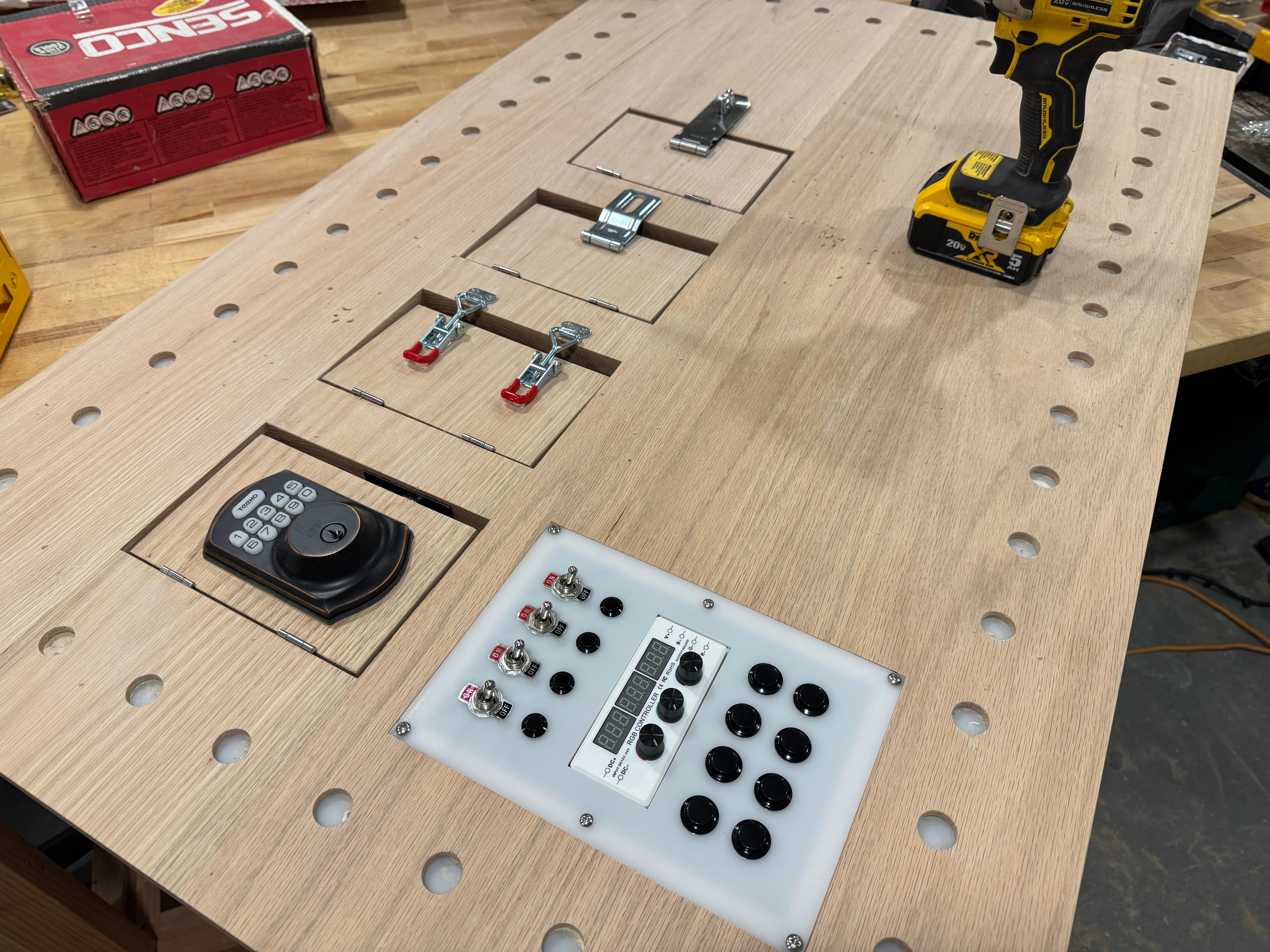 Completed oak busy board with switches, locks, lights, and controls