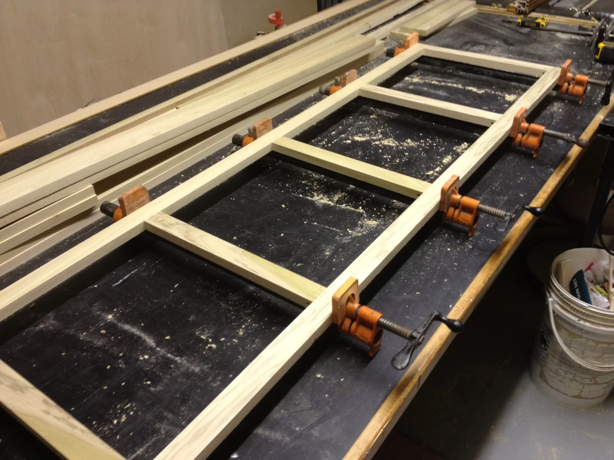 Wooden frame of the photo desk clamped during construction